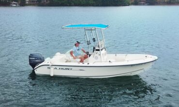 a person sitting on a keowee marinas sea hunt center console rental on lake keowee