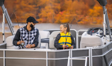 Father and child fishing on pontoon boat by Keowee Marina – best boat rental in South Carolina