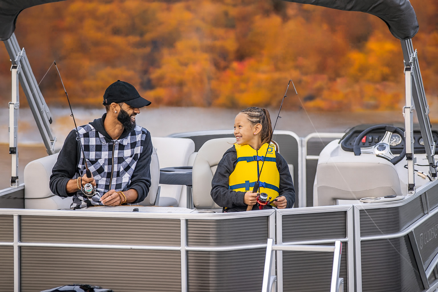 Father and child fishing on pontoon boat by Keowee Marina – best boat rental in South Carolina