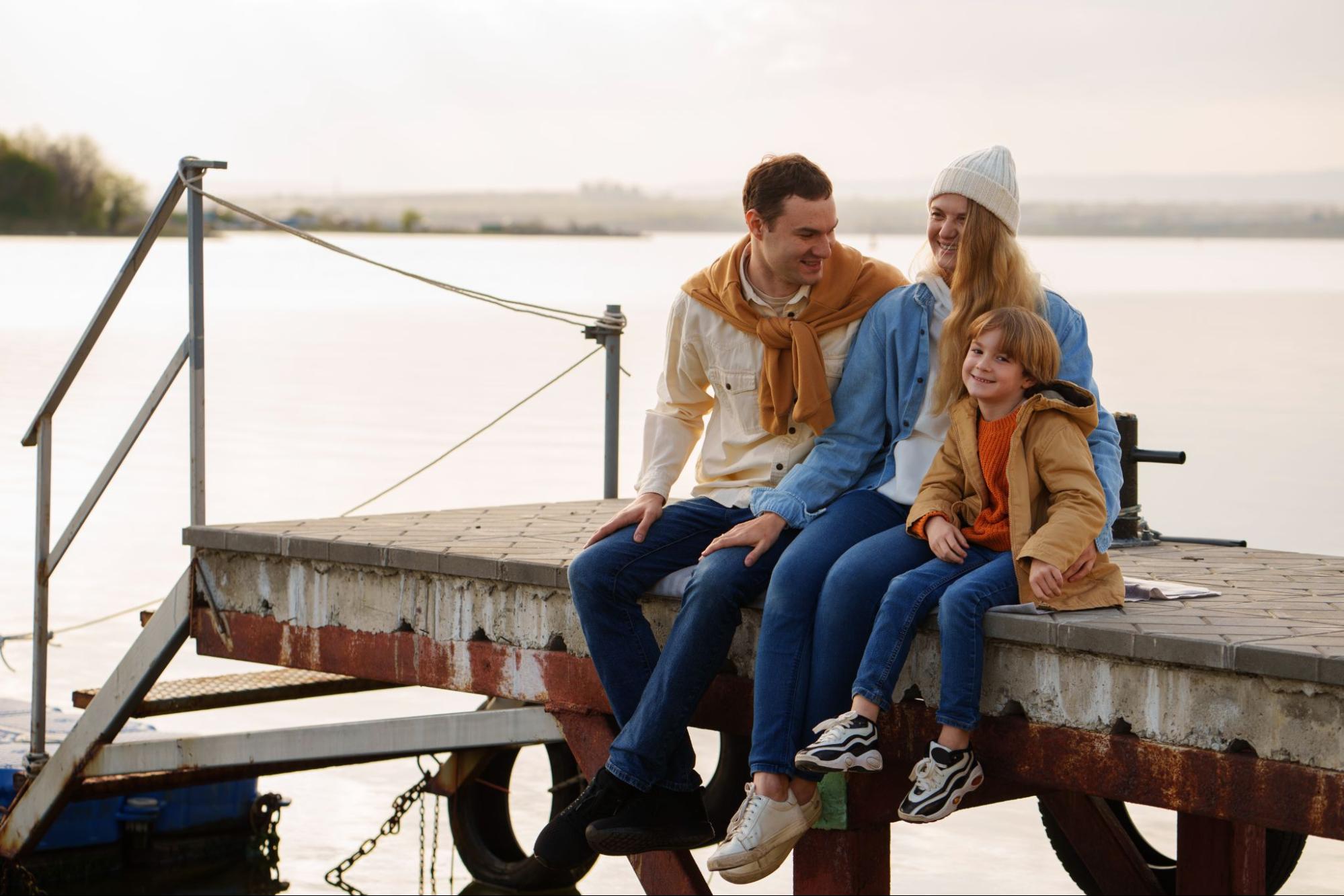 Family spending quality time together outdoors by the lake Keowee boat dock at sunset