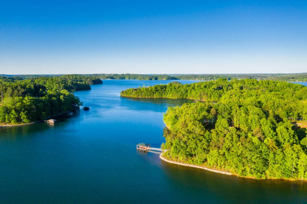Aerial view of Lake Keowee with lush green shoreline and clear blue water | Keowee Marina