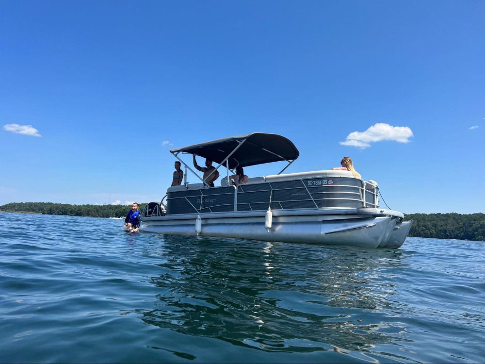 Family spending quality time at Lake Keowee on Tritoon - Keowee Marina