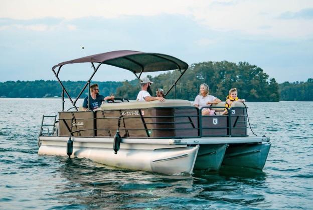 Family enjoying a pontoon boat cruise on Lake Keowee 