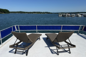 Houseboat deck with lounge chairs overlooking Lake Keowee