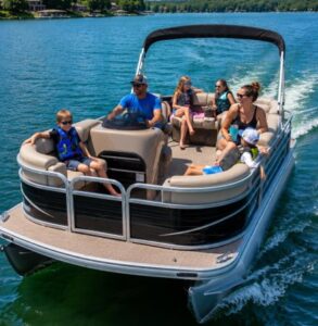 Family cruising Lake Keowee on a pontoon boat with life jackets